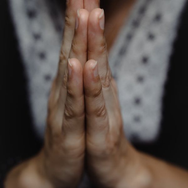 Close-up of a person's hands in a meditative yoga mudra.